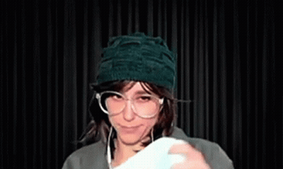 Woman In Glasses And Green Hat Smiling GIF