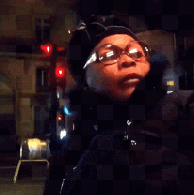 Woman In Glasses And Hat At Red Light GIF
