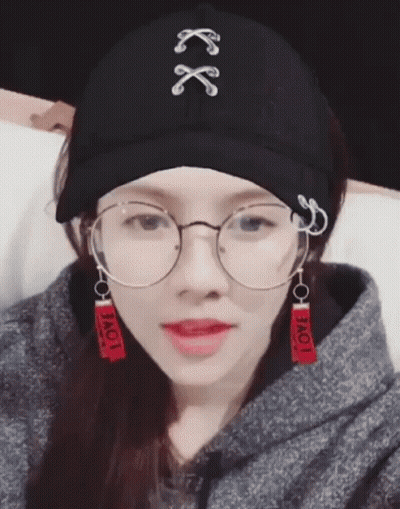 Woman In Glasses And Hat Saying Love GIF