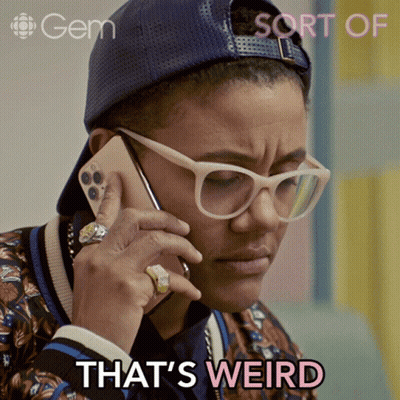 Woman In Glasses And Hat Talking On Phone Saying That's Weird GIF