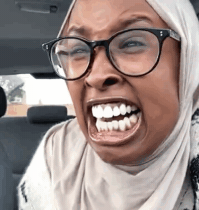 Woman in Glasses and Hijab Making Funny Face While Driving