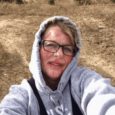 Woman In Glasses And Hoodie With Blood On Face GIF
