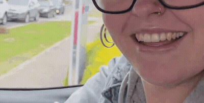 Woman In Glasses And Hoop Earrings Smiling GIF