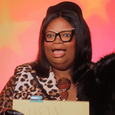 Woman In Glasses And Leopard Jacket Holding I Love You Sign GIF