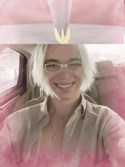Woman In Glasses And Necklace Smiling In Car GIF
