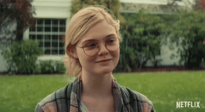 Woman In Glasses And Plaid Shirt Smiling Netflix Ad GIF