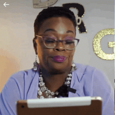 Woman In Glasses And Purple Shirt Looking At Tablet GIF