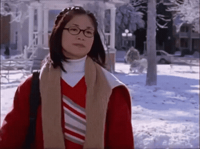 Woman In Glasses And Red Jacket Standing In Snow GIF