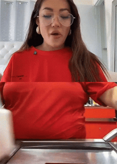 Woman In Glasses And Red Shirt At Counter GIF