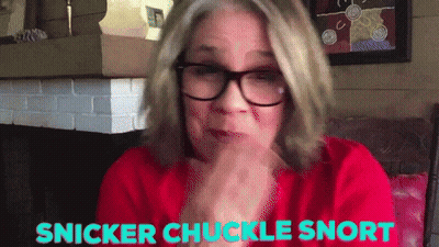 Woman In Glasses And Red Shirt Says Snicker Chuckle Snort GIF