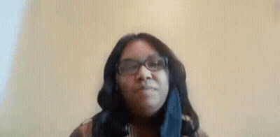 Woman In Glasses And Scarf Making Funny Face GIF