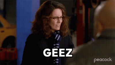 Woman In Glasses And Scarf Saying Geez To Man GIF