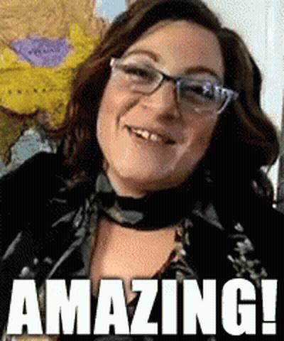 Woman In Glasses And Scarf Smiling Saying Amazing GIF