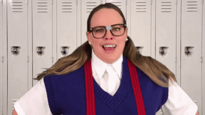 Woman In Glasses And Sweater Vest By Lockers GIF