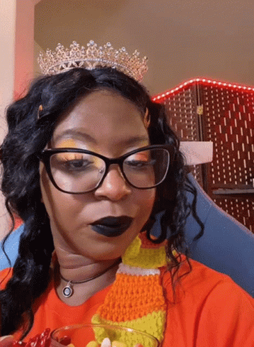 Woman In Glasses And Tiara Holding Candy Corn GIF