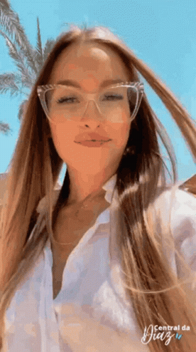 Woman In Glasses And White Shirt Posing GIF