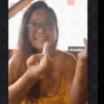 Woman In Glasses Giving Middle Finger In Mirror GIF
