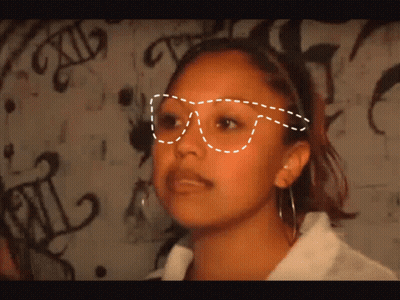 Woman In Glasses In Front Of Graffiti Saying XII GIF