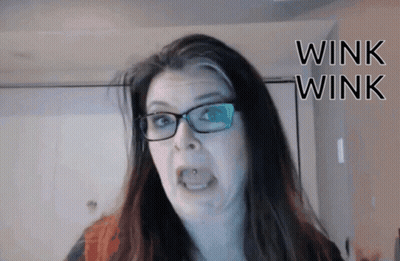 Woman In Glasses Making Funny Face Wink Wink GIF