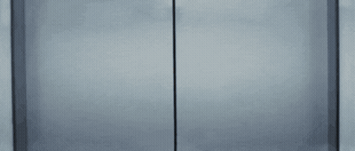 Woman In Glasses Peeking Out Of Door GIF
