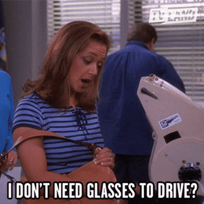 Woman In Glasses Peeking Out Of Door GIF