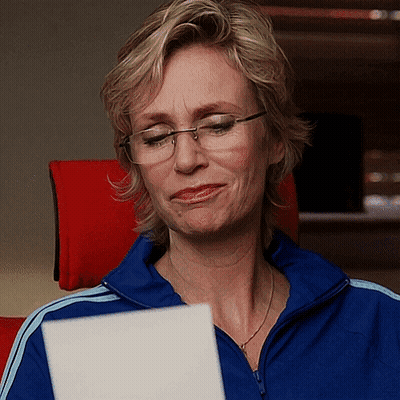 Woman In Glasses Reading Paper GIF