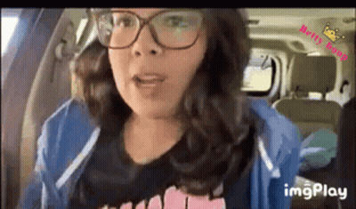 Woman In Glasses Sitting In Car Talking GIF