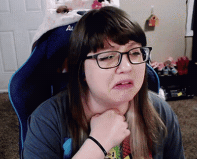 Woman In Glasses Sitting In Chair Saying Al GIF