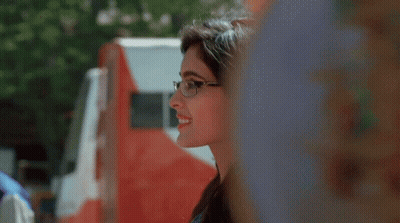 Woman In Glasses Smiling By Red And White Truck GIF