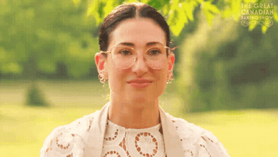 Woman In Glasses Smiling In Field GIF