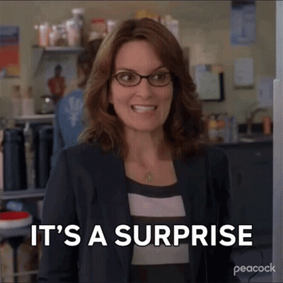 Woman In Glasses Smiling Saying It's A Surprise GIF