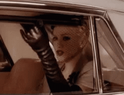 Woman In Gloves Sitting In Car GIF