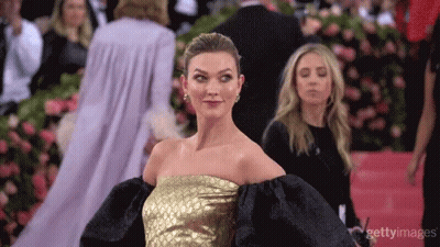 Woman In Gold And Black Dress On Red Carpet GIF