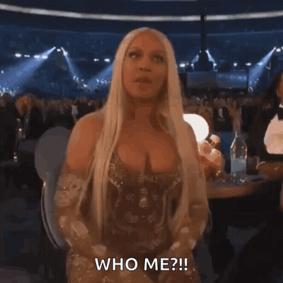 Woman In Gold Dress Asking Who Me GIF