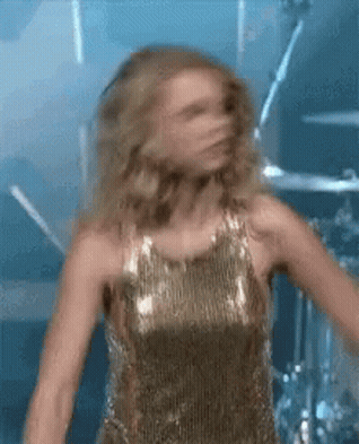 Woman In Gold Dress Dancing On Stage GIF