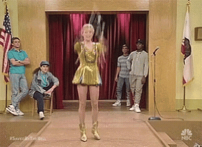 Woman In Gold Dress Dancing On Stage With Crowd GIF