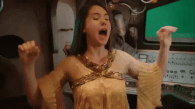 Woman In Gold Dress Screaming Arms Up GIF
