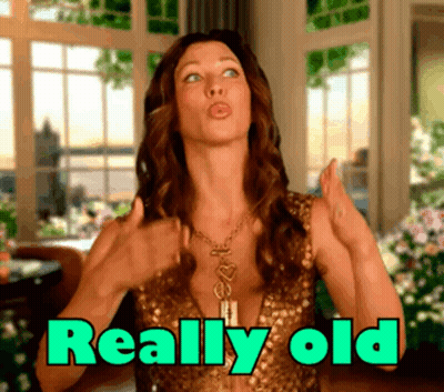 Woman In Gold Dress Thumbs Up Saying Really Old GIF