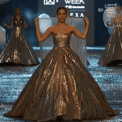 Woman In Gold Dress Walking At Lakme Fashion Week GIF