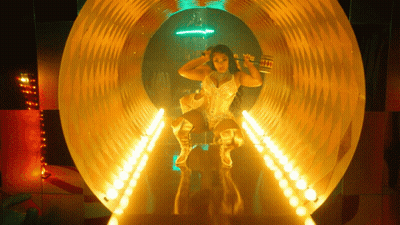 Woman In Gold Outfit In Tunnel With Lights GIF