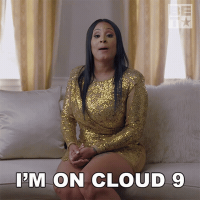 Woman In Gold Sequined Dress Says I'm On Cloud 9 GIF
