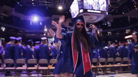 Woman In Graduation Cap And Gown Dancing GIF