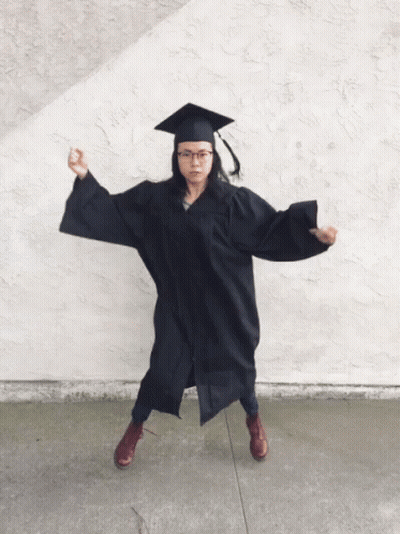 Woman In Graduation Cap And Gown Flexing GIF