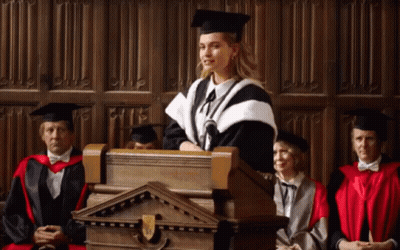 Woman In Graduation Cap And Gown Giving Speech GIF