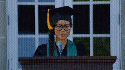 Woman In Graduation Cap And Gown Giving Speech GIF