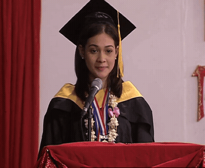 Woman In Graduation Cap And Gown Giving Speech GIF
