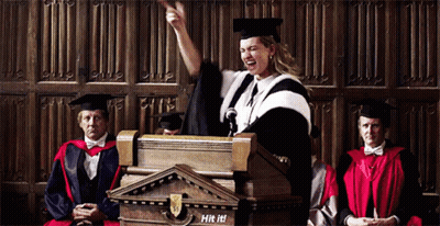 Woman In Graduation Cap And Gown Giving Speech GIF