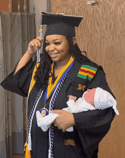 Woman In Graduation Cap And Gown Holding Baby GIF