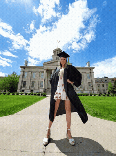Woman In Graduation Cap And Gown In Front Of Building GIF