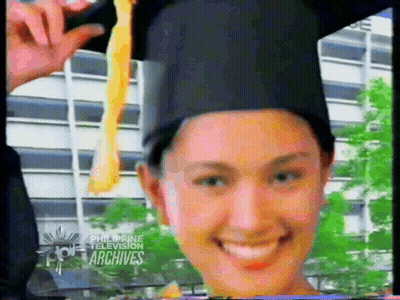 Woman In Graduation Cap And Gown Smiling GIF